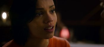 Movie still from “Black Mirror” (2011), created by Charlie Brooker – A woman's face in a dark room; Close Up shot, Over the shoulder angle