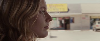 Movie still from “Greenberg” (2010), directed by Noah Baumbach – A woman's face in front of a store window; Close Up shot, Low angle