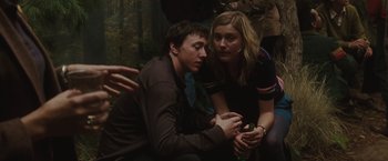 Movie still from “Greenberg” (2010), directed by Noah Baumbach – A man and a woman sitting next to each other on the ground; Medium shot, Over the shoulder angle
