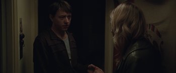 Movie still from “Greenberg” (2010), directed by Noah Baumbach – A man and a woman standing next to each other in a room; Medium shot, Over the shoulder angle