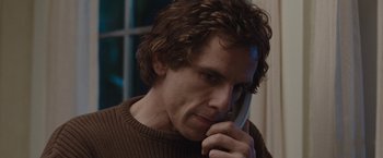 Movie still from “Greenberg” (2010), directed by Noah Baumbach – A person talking on a cell phone; Close Up shot, High angle