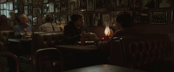 Movie still from “Greenberg” (2010), directed by Noah Baumbach – Two people sitting at a table in front of a lit candle; Medium shot, Over the shoulder angle