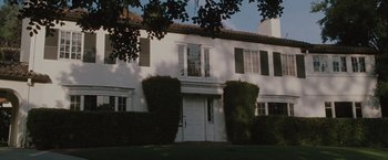 Movie still from “Greenberg” (2010), directed by Noah Baumbach – A large white house with a green lawn in front of it; Extreme Wide shot, Low angle