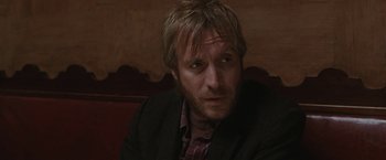 Movie still from “Greenberg” (2010), directed by Noah Baumbach – A person wearing a suit and tie; Close Up shot, Over the shoulder angle