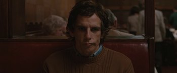 Movie still from “Greenberg” (2010), directed by Noah Baumbach – A man in a brown sweater sitting on a bench; Close Up shot, Over the shoulder angle