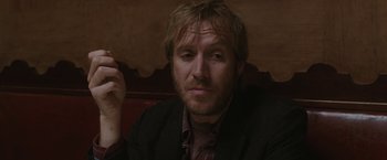 Movie still from “Greenberg” (2010), directed by Noah Baumbach – A person wearing a suit and tie; Close Up shot, Over the shoulder angle