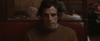 Movie still from “Greenberg” (2010), directed by Noah Baumbach – A person sitting in a chair wearing a sweater; Close Up shot, Over the shoulder angle