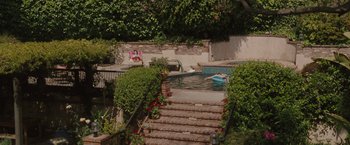 Movie still from “Greenberg” (2010), directed by Noah Baumbach – A man is swimming in a pool by the stairs; Extreme Wide shot, High angle