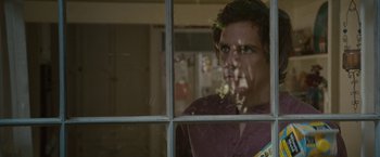 Movie still from “Greenberg” (2010), directed by Noah Baumbach – A man looking out of a window at a house; Close Up shot, Over the shoulder angle