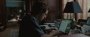 Movie still from “Greenberg” (2010), directed by Noah Baumbach – A man sitting in front of a laptop computer; Medium shot, Over the shoulder angle
