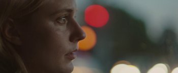 Movie still from “Greenberg” (2010), directed by Noah Baumbach – A woman's face with lights in the background; Extreme Close Up shot, Over the shoulder angle