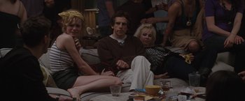 Movie still from “Greenberg” (2010), directed by Noah Baumbach – A group of people sitting on a couch in a room; Medium shot, Over the shoulder angle