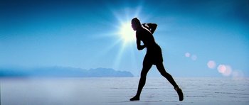 Movie still from “Haider” (2014), directed by Vishal Bhardwaj – A man is running on the beach with the sun in the background; Wide shot, Low angle