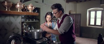 Movie still from “Haider” (2014), directed by Vishal Bhardwaj – A man and a woman are cooking in a kitchen; Medium shot, Low angle