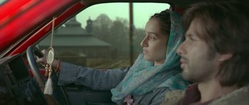 Movie still from “Haider” (2014), directed by Vishal Bhardwaj – A woman sitting in the driver's seat of a car; Close Up shot, Over the shoulder angle