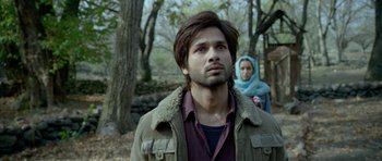 Movie still from “Haider” (2014), directed by Vishal Bhardwaj – A man and a woman standing next to each other in the woods; Close Up shot, Low angle