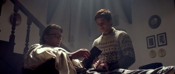 Movie still from “Haider” (2014), directed by Vishal Bhardwaj – A man and a young boy are looking at a book; Medium shot, Low angle