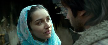 Movie still from “Haider” (2014), directed by Vishal Bhardwaj – A woman with a blue head scarf looking at a man with a beard; Close Up shot, Over the shoulder angle