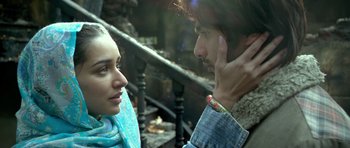 Movie still from “Haider” (2014), directed by Vishal Bhardwaj – A man and a woman talking on a cell phone; Close Up shot, Low angle