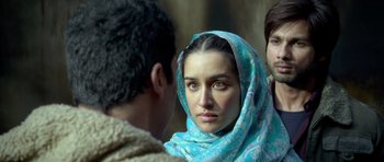 Movie still from “Haider” (2014), directed by Vishal Bhardwaj – A woman with a blue head scarf looking at the camera; Close Up shot, Over the shoulder angle