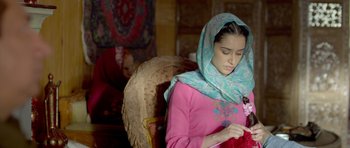 Movie still from “Haider” (2014), directed by Vishal Bhardwaj – A woman in a pink shirt wearing a blue head scarf; Medium shot, Low angle