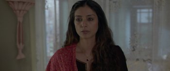 Movie still from “Haider” (2014), directed by Vishal Bhardwaj – A person with long hair wearing a necklace; Close Up shot, High angle