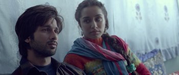 Movie still from “Haider” (2014), directed by Vishal Bhardwaj – A man and a woman are standing next to each other; Close Up shot, Low angle