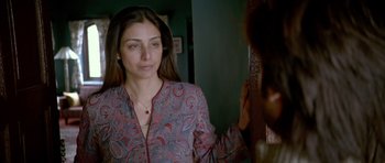 Movie still from “Haider” (2014), directed by Vishal Bhardwaj – A woman looking in the mirror while wearing a necklace; Close Up shot, Over the shoulder angle