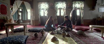Movie still from “Haider” (2014), directed by Vishal Bhardwaj – Two people sitting on the ground in a room; Wide shot, High angle