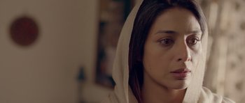 Movie still from “Haider” (2014), directed by Vishal Bhardwaj – A person wearing a hooded sweatshirt; Close Up shot, High angle