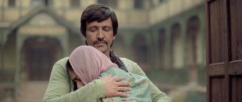 Movie still from “Haider” (2014), directed by Vishal Bhardwaj – A man holding a woman in her arms; Close Up shot, Over the shoulder angle