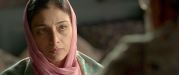 Movie still from “Haider” (2014), directed by Vishal Bhardwaj – A person wearing a pink head scarf; Close Up shot, Over the shoulder angle