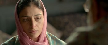 Movie still from “Haider” (2014), directed by Vishal Bhardwaj – A person wearing a pink head scarf; Close Up shot, Over the shoulder angle