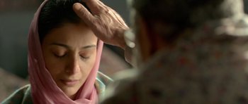 Movie still from “Haider” (2014), directed by Vishal Bhardwaj – A woman is getting her hair done by a man; Close Up shot, Over the shoulder angle
