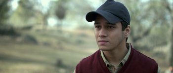 Movie still from “Haider” (2014), directed by Vishal Bhardwaj – A young man wearing a hat and a sweater; Close Up shot, High angle