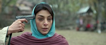 Movie still from “Haider” (2014), directed by Vishal Bhardwaj – A woman in a blue headscarf is holding a cell phone; Close Up shot, Overhead angle