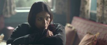 Movie still from “Haider” (2014), directed by Vishal Bhardwaj – A woman sitting in a chair with her hand on her chin; Close Up shot, Over the shoulder angle