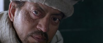 Movie still from “Haider” (2014), directed by Vishal Bhardwaj – A person with a hat on; Extreme Close Up shot, High angle