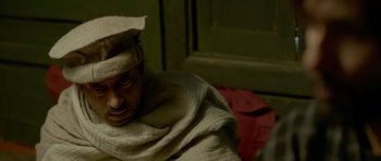 Movie still from “Haider” (2014), directed by Vishal Bhardwaj – A person wearing a hat and a blanket; Close Up shot, High angle