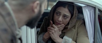 Movie still from “Haider” (2014), directed by Vishal Bhardwaj – A woman with a scarf on looking at a man in the mirror; Close Up shot, Over the shoulder angle