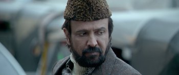 Movie still from “Haider” (2014), directed by Vishal Bhardwaj – A person with a beard wearing a hat; Close Up shot, Low angle
