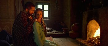 Movie still from “Haider” (2014), directed by Vishal Bhardwaj – A man and a woman sitting on the ground in front of a window; Medium shot, Low angle