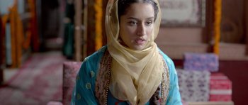 Movie still from “Haider” (2014), directed by Vishal Bhardwaj – A woman in a blue dress with a yellow head scarf; Close Up shot, Low angle