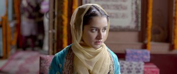 Movie still from “Haider” (2014), directed by Vishal Bhardwaj – A young woman wearing a headscarf looking at the camera; Close Up shot, Over the shoulder angle