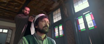 Movie still from “Haider” (2014), directed by Vishal Bhardwaj – A man with a beard is getting his hair cut; Close Up shot, Low angle