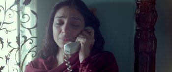 Movie still from “Haider” (2014), directed by Vishal Bhardwaj – A woman holding a phone up to her ear; Close Up shot, Overhead angle