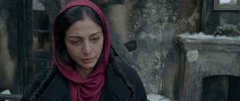 Movie still from “Haider” (2014), directed by Vishal Bhardwaj – A woman in a black coat and a red head scarf; Close Up shot, Over the shoulder angle