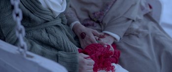 Movie still from “Haider” (2014), directed by Vishal Bhardwaj – A woman holding a child's hand while wearing a sweater; Extreme Close Up shot, Overhead angle