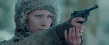 Movie still from “Hanna” (2011), directed by Joe Wright – A young person wearing a winter coat and a fur hat; Close Up shot, Over the shoulder angle