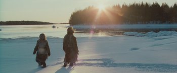 Movie still from “Hanna” (2011), directed by Joe Wright – A person standing in the middle of a snow covered field; Extreme Wide shot, High angle
